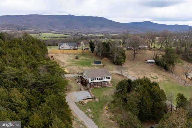birds eye view of property featuring a mountain view and a rural view