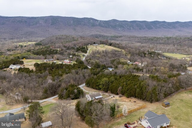 bird's eye view featuring a wooded view and a mountain view