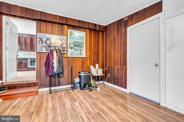 miscellaneous room with wood finished floors and wood walls