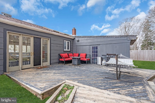deck featuring outdoor lounge area and fence