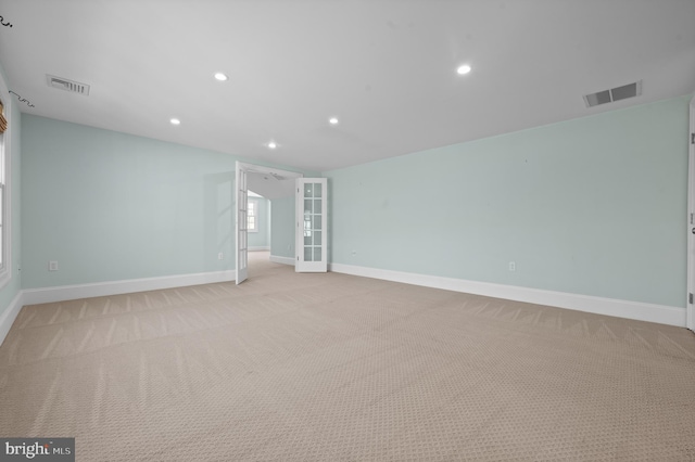 unfurnished room featuring recessed lighting, baseboards, visible vents, and light colored carpet