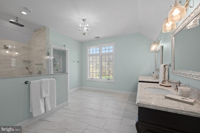 full bath featuring marble finish floor, baseboards, walk in shower, and a sink