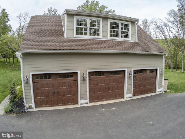 garage featuring aphalt driveway
