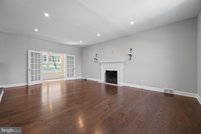unfurnished living room featuring a fireplace with flush hearth, visible vents, recessed lighting, and dark wood-type flooring