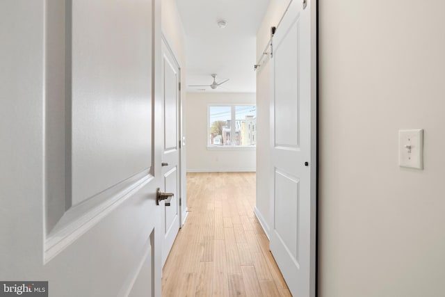 1649 N Randolph St, Philadelphia, PA 19122 - corridor featuring light wood finished floors, a barn door, and baseboards