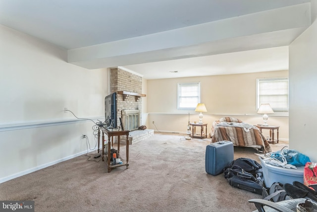 living area featuring carpet flooring, baseboards, and a fireplace