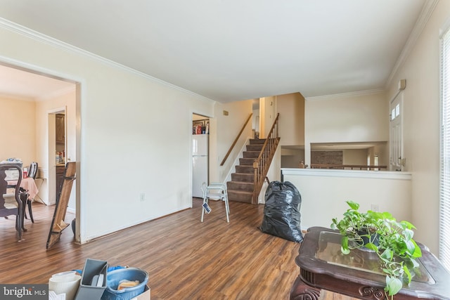 interior space with stairway, ornamental molding, wood finished floors, and a healthy amount of sunlight