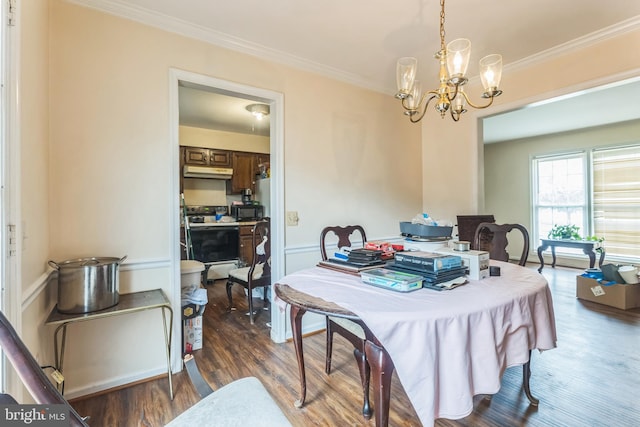 dining area with crown molding, an inviting chandelier, and dark wood-type flooring