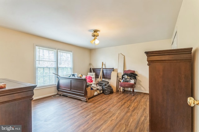 bedroom with baseboards and wood finished floors