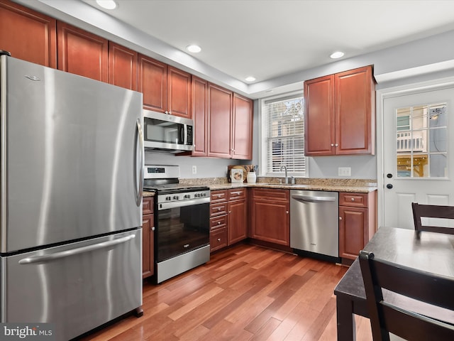 1614 Patapsco St, Baltimore, MD 21230 - kitchen with appliances with stainless steel finishes, recessed lighting, light wood-type flooring, and light stone counters