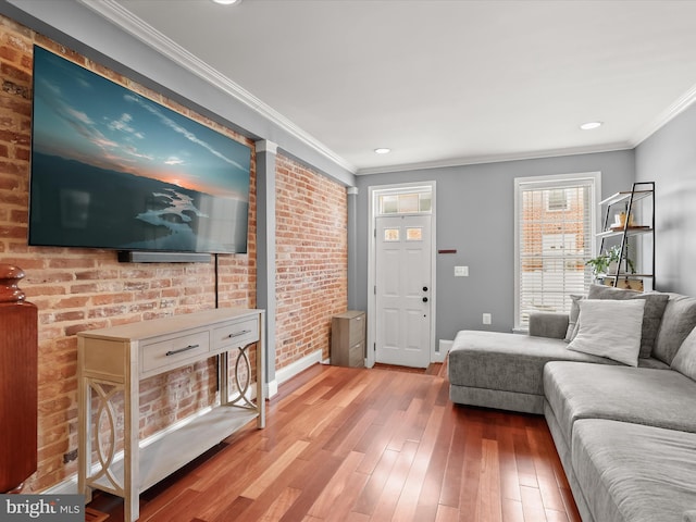1614 Patapsco St, Baltimore, MD 21230 - living area featuring wood-type flooring, crown molding, recessed lighting, and brick wall