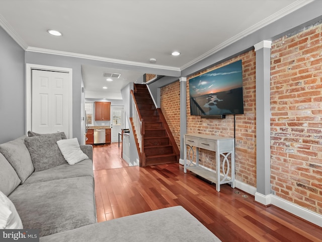 1614 Patapsco St, Baltimore, MD 21230 - living room featuring ornamental molding, light wood-style flooring, stairs, recessed lighting, and brick wall