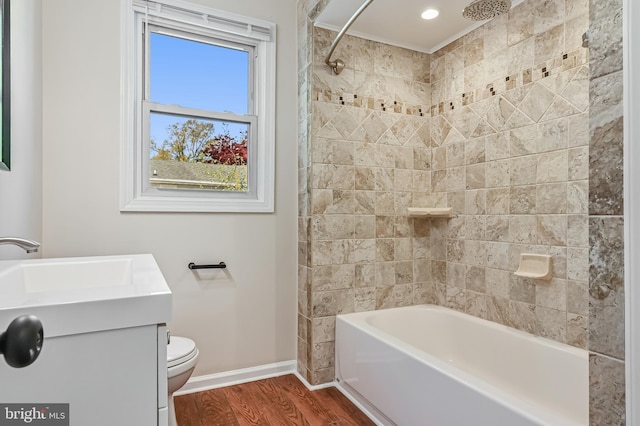 full bathroom with a sink, toilet, baseboards, wood finished floors, and washtub / shower combination