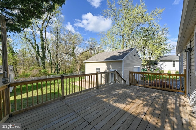 deck with a lawn and an outdoor structure