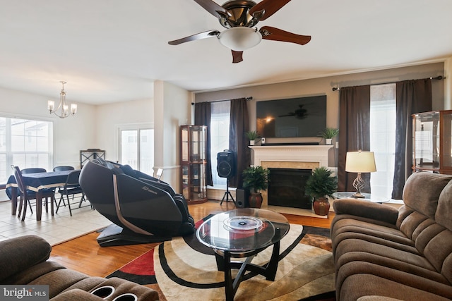 8509 Lexington Dr, Severn, MD 21144 - living area featuring ceiling fan with notable chandelier, a fireplace, and wood finished floors