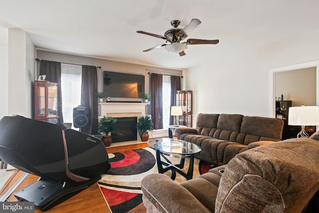 8509 Lexington Dr, Severn, MD 21144 - living area featuring a fireplace with flush hearth, wood finished floors, and ceiling fan