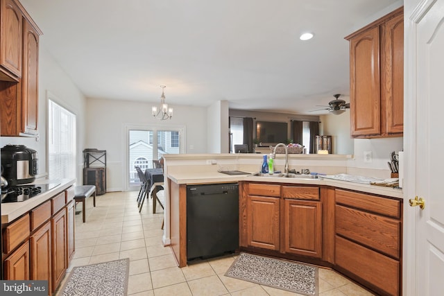8509 Lexington Dr, Severn, MD 21144 - kitchen with light tile patterned floors, a sink, black appliances, a peninsula, and brown cabinetry