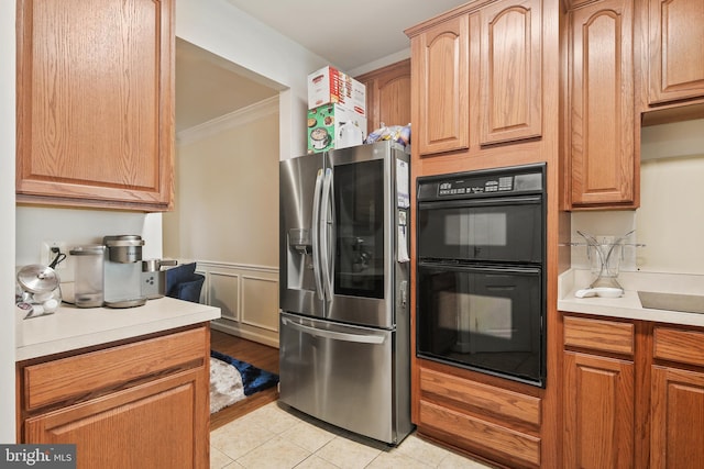 8509 Lexington Dr, Severn, MD 21144 - kitchen with light tile patterned flooring, light countertops, crown molding, dobule oven black, and stainless steel fridge with ice dispenser