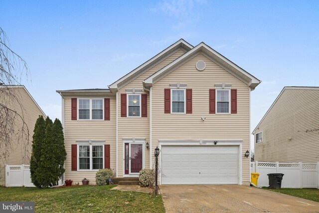 8509 Lexington Dr, Severn, MD 21144 - view of front of property with a front lawn, driveway, an attached garage, and fence