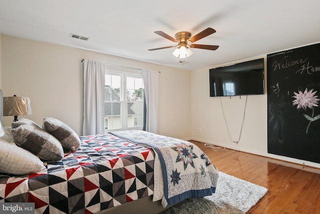 8509 Lexington Dr, Severn, MD 21144 - bedroom with baseboards, visible vents, wood finished floors, and ceiling fan
