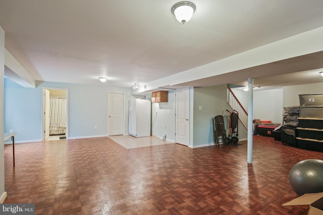 8509 Lexington Dr, Severn, MD 21144 - finished below grade area with baseboards, white fridge with ice dispenser, and stairway