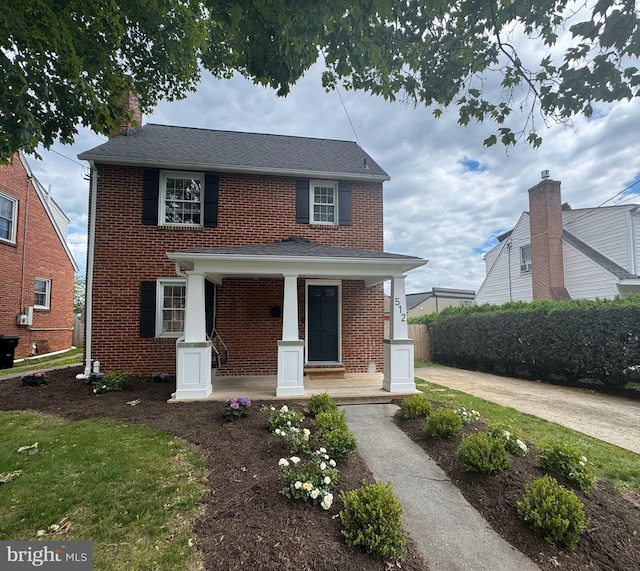 512 Dunlap St, Winchester, VA 22601 - view of front of home with covered porch, brick siding, a chimney, and a shingled roof