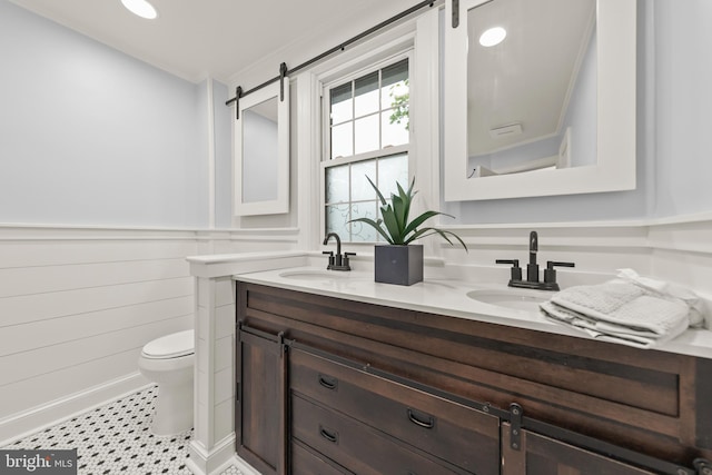 512 Dunlap St, Winchester, VA 22601 - bathroom featuring double vanity, toilet, and a wainscoted wall
