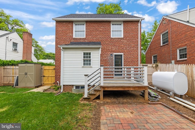 512 Dunlap St, Winchester, VA 22601 - rear view of house featuring a deck, heating fuel, a storage shed, and a shingled roof