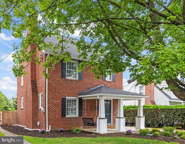 512 Dunlap St, Winchester, VA 22601 - view of front of property featuring a shingled roof, brick siding, and a porch