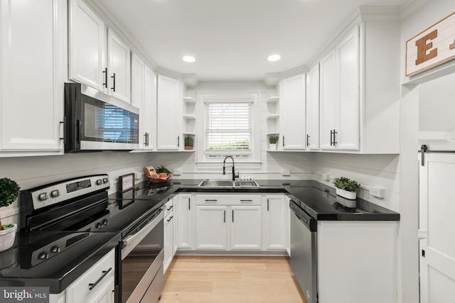 512 Dunlap St, Winchester, VA 22601 - kitchen featuring stainless steel appliances, a sink, open shelves, dark countertops, and white cabinets
