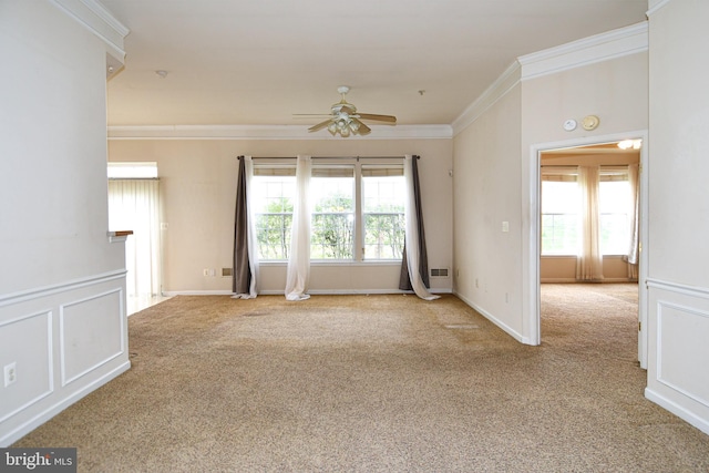 unfurnished room with plenty of natural light, carpet flooring, crown molding, and ceiling fan