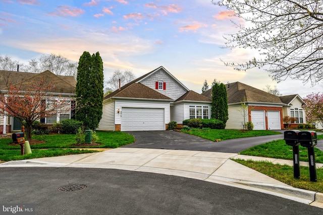 view of front of home featuring an attached garage, aphalt driveway, brick siding, and a lawn