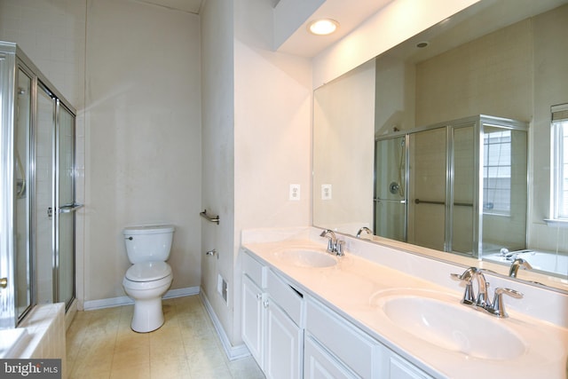 bathroom with a sink, toilet, double vanity, and a stall shower