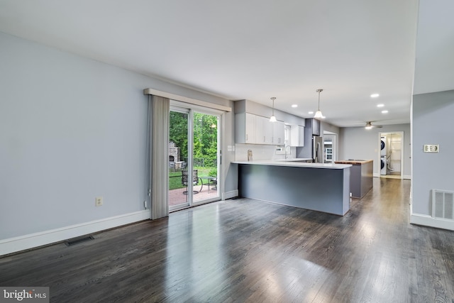 kitchen with a peninsula, freestanding refrigerator, baseboards, light countertops, and recessed lighting