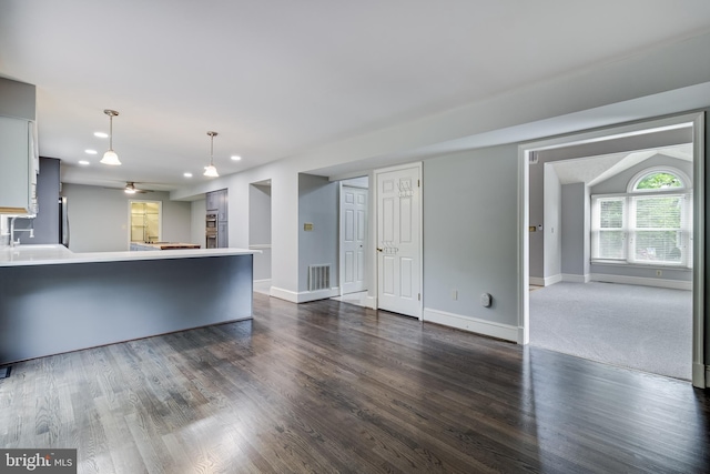 unfurnished living room with dark wood finished floors, visible vents, baseboards, ceiling fan, and recessed lighting