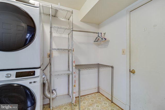 laundry room with stacked washing maching and dryer and laundry area