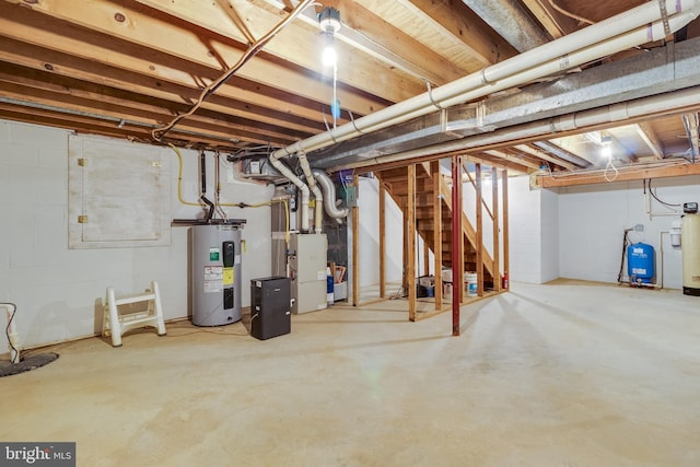 unfinished below grade area with water heater, stairs, and heating unit