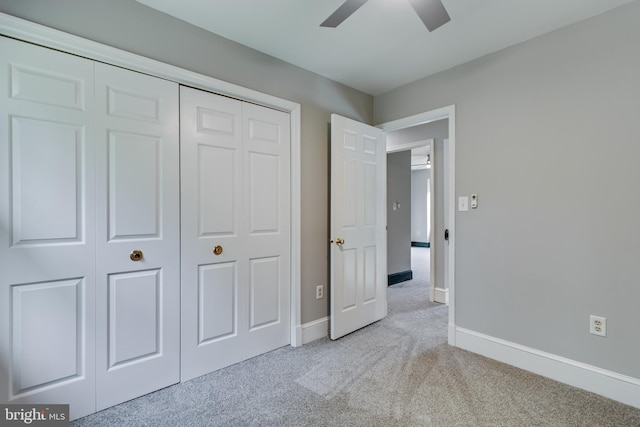 unfurnished bedroom with a ceiling fan, carpet floors, baseboards, and a closet