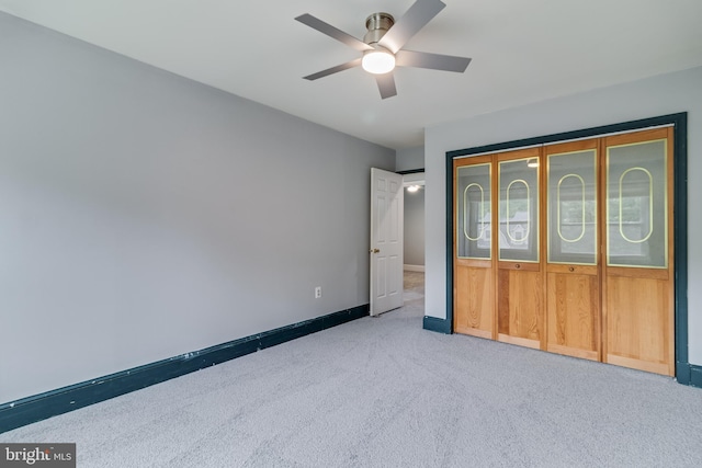 unfurnished bedroom featuring carpet flooring, baseboards, and ceiling fan