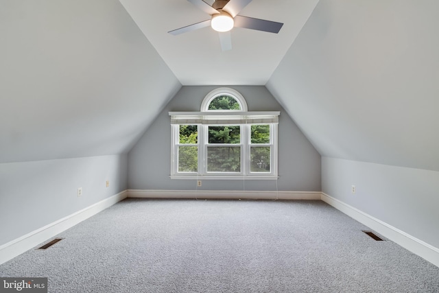 additional living space with lofted ceiling, visible vents, and carpet floors