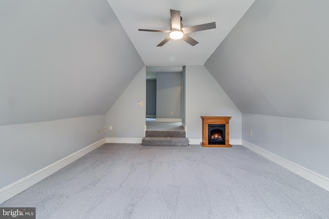 bonus room with carpet flooring, vaulted ceiling, baseboards, and a ceiling fan