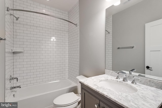 bathroom with toilet, vanity, and shower / washtub combination