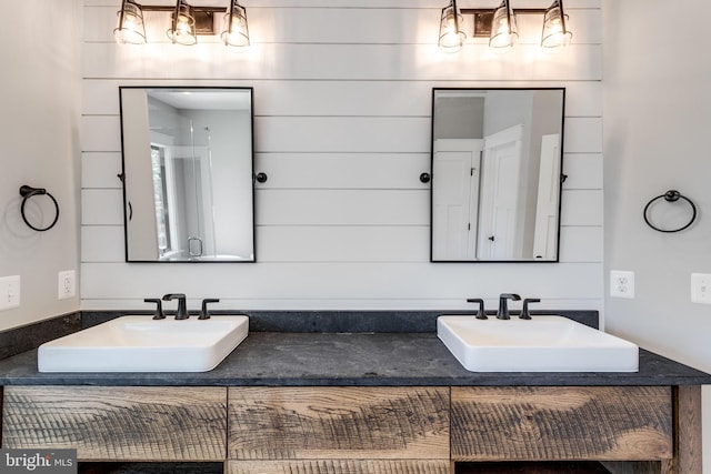 bathroom featuring double vanity and a sink