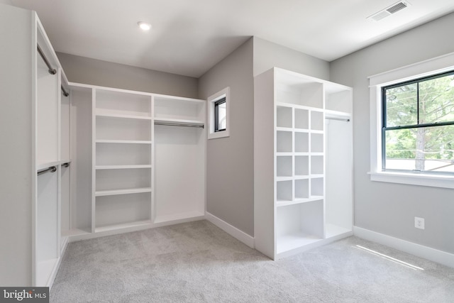 spacious closet featuring visible vents and carpet