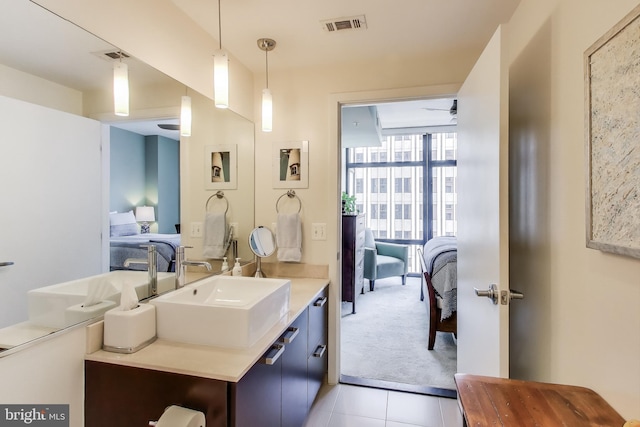 bathroom featuring visible vents, vanity, ensuite bathroom, and tile patterned flooring