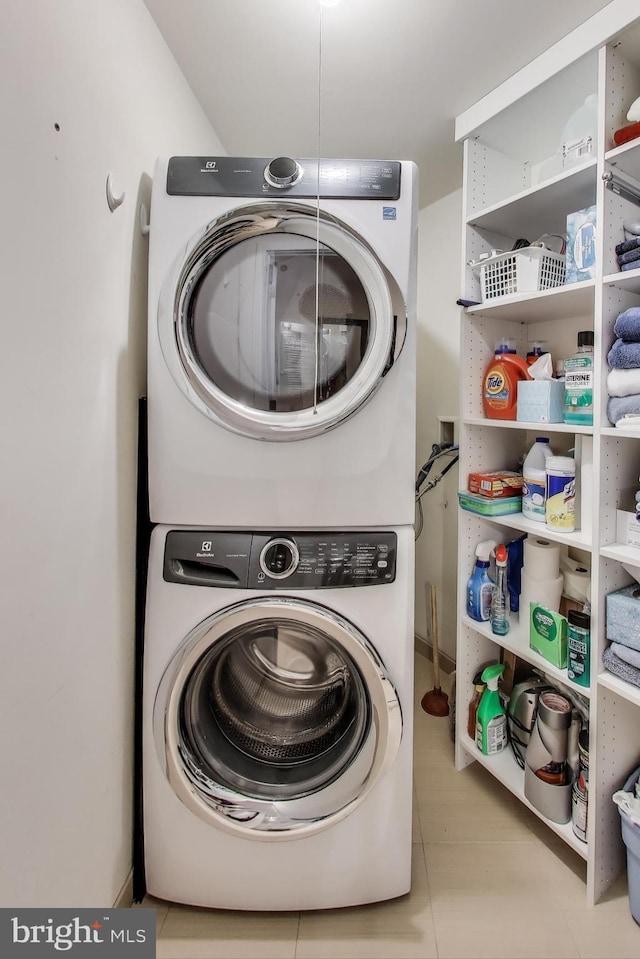 laundry room featuring stacked washer and dryer and laundry area