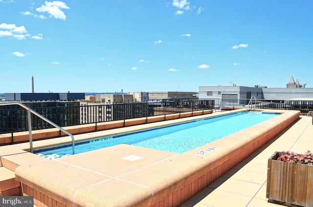 view of pool featuring a view of city