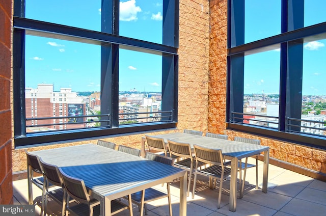 dining space with a city view and tile patterned flooring