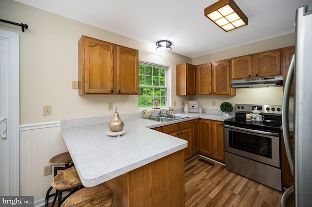 55 Hamn, Stafford, VA 22554 - kitchen with a sink, a peninsula, stainless steel appliances, a breakfast bar, and under cabinet range hood