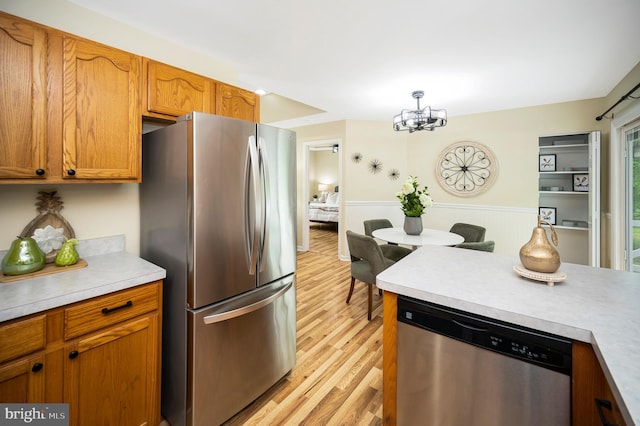 55 Hamn, Stafford, VA 22554 - kitchen featuring brown cabinets, light countertops, stainless steel appliances, and light wood-style floors